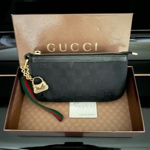 Authentic monogram Gucci GG wristlet pochette